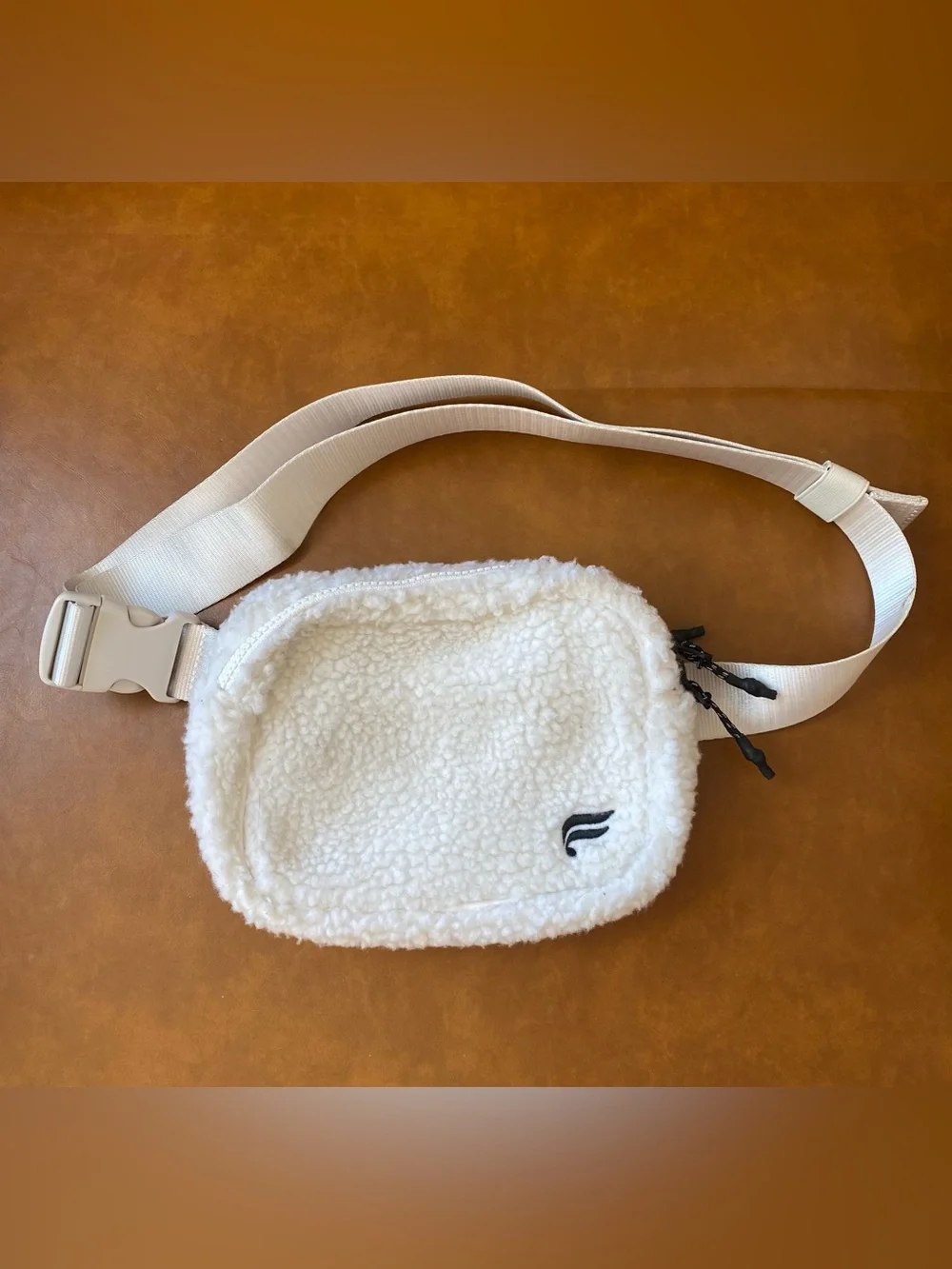 Fabletics The Belt Bag Teddy in color Bone Sherpa Crossbody Bag with Wide Strap